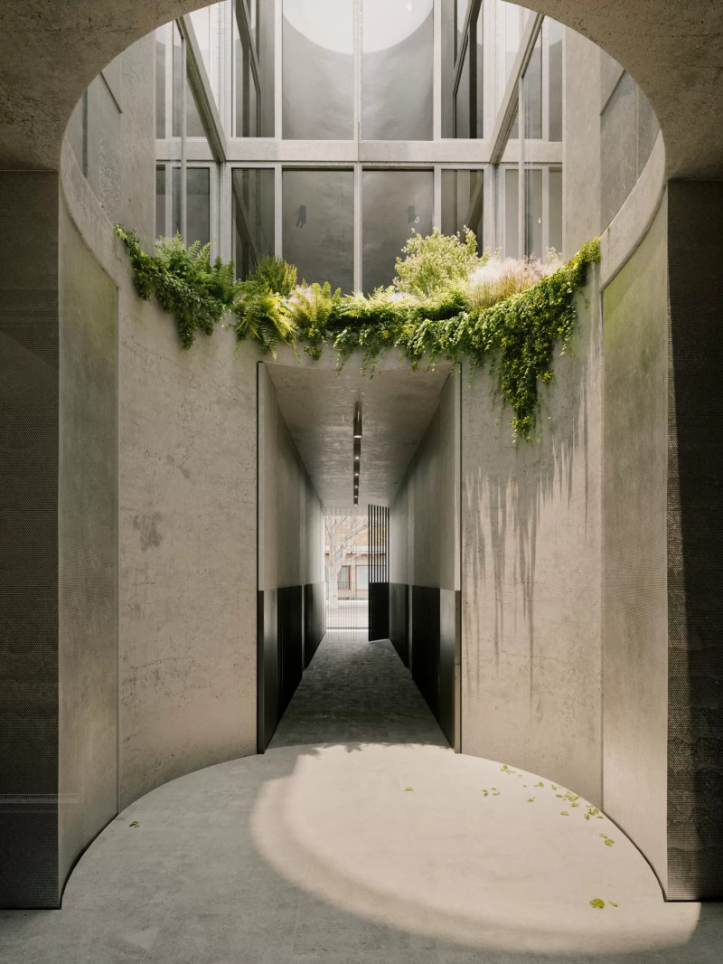 Render of the entrance lobby of Napier Street. The lobby is open, concrete and has natural light streaming in from above.