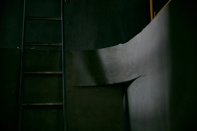 Dark image of a curved concrete wall